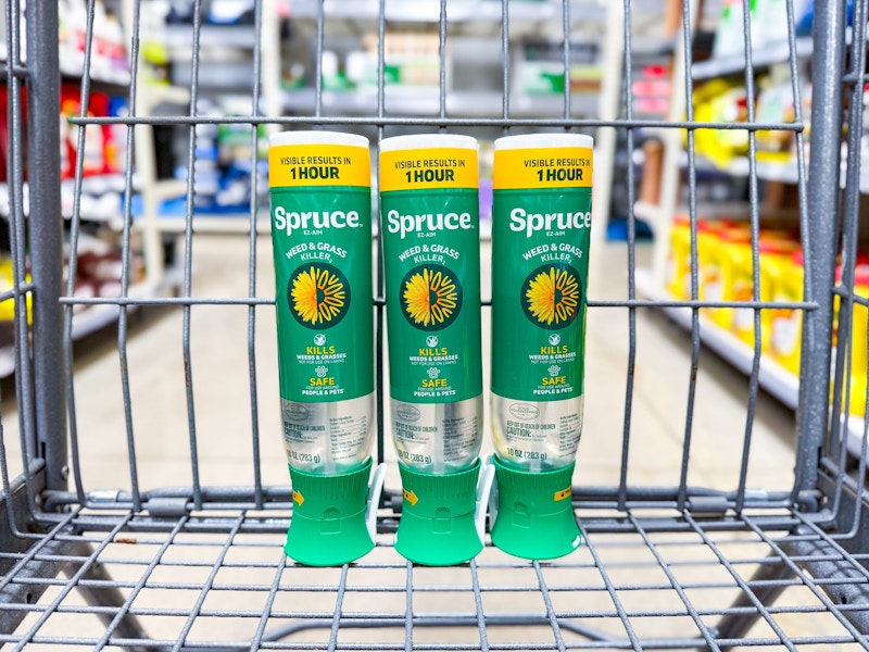 three bottles of spruce grass and weed killer in walmart cart