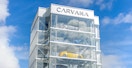 The sign on a Carvana vending machine building with vehicles inside