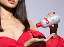 a person pouring hair serum in their hand