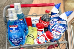crest mouthwash, sun bum hair mask, gold bond lotion, old spice deodorant, coca-cola, and lysol toilet cleaner in a cart
