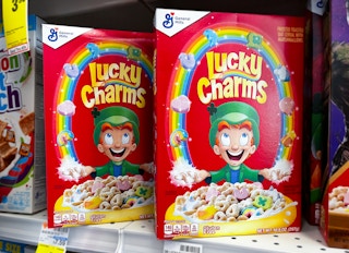 two boxes of lucky charms cereal on a store shelf