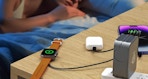 a charging station charging an Apple watch, phones, and Airpods