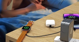 a charging station charging an Apple watch, phones, and Airpods