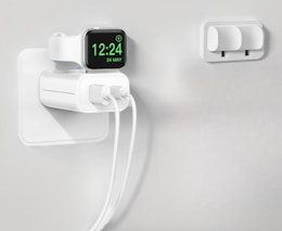 an Apple watch on a charger plugged into an outlet
