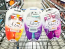 3 packs of bic soleil razors sitting in the front of a walmart cart