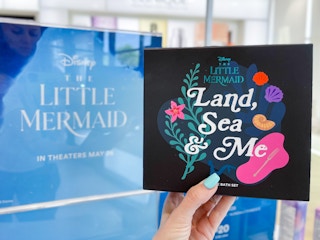 hand holding up the new little mermaid collection at ulta