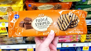 hand holds Kroger brand fudge striped cookies