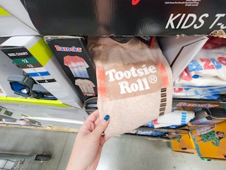 hand holding a kids' tootsie roll t-shirt