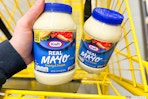 hand holding kraft mayo in a yellow shopping cart