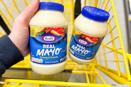 hand holding kraft mayo in a yellow shopping cart