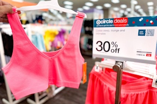 hand holding a colsie bralette in front of a target promotion sign