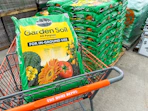 a bag of miracle gro in home depot cart