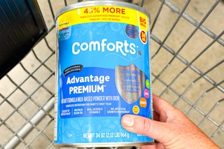 hand holding a can of comforts infant formula