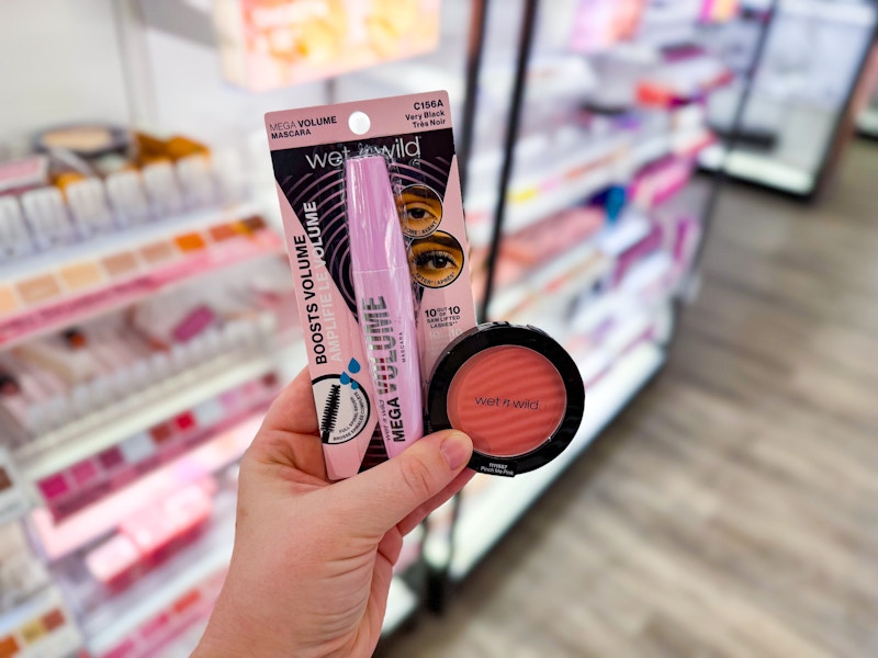 person holding wet n wild mascara and blush