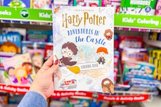 hand holding up a harry potter coloring book at dollar tree