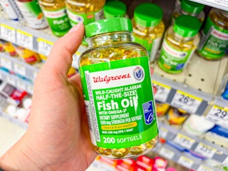 hand holding walgreens fish oil softgels