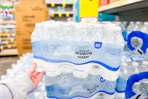 person grabbing a 24-pack of bottled water