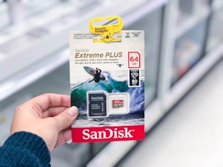 hand holding a sandisk memory card at target