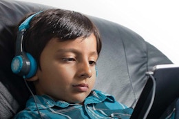 a kid wearing jlab headphones