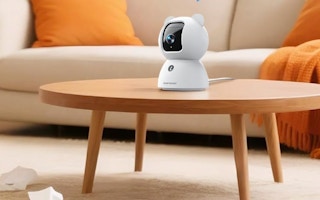 a small security pet camera on a wooden table