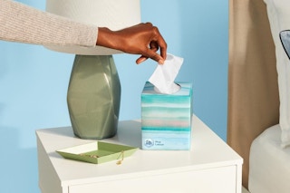 woman pulling a tissue out of box