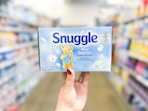 hand holding a 200 count package of Snuggle dryer sheets