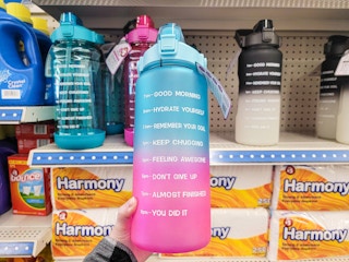 person holding a motivational water bottle