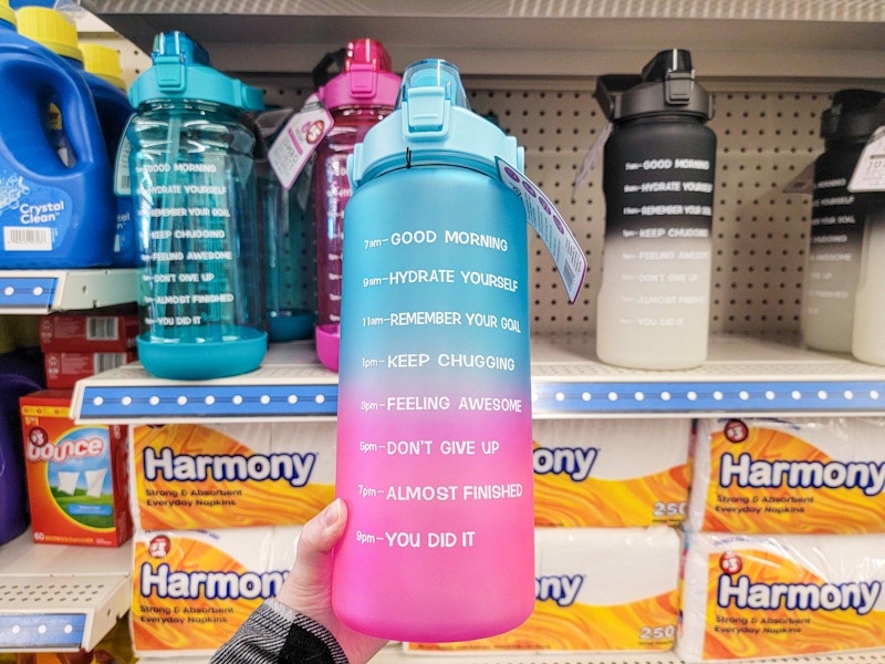 person holding a motivational water bottle