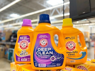 three yellow bottles of Arm & Hammer detergent