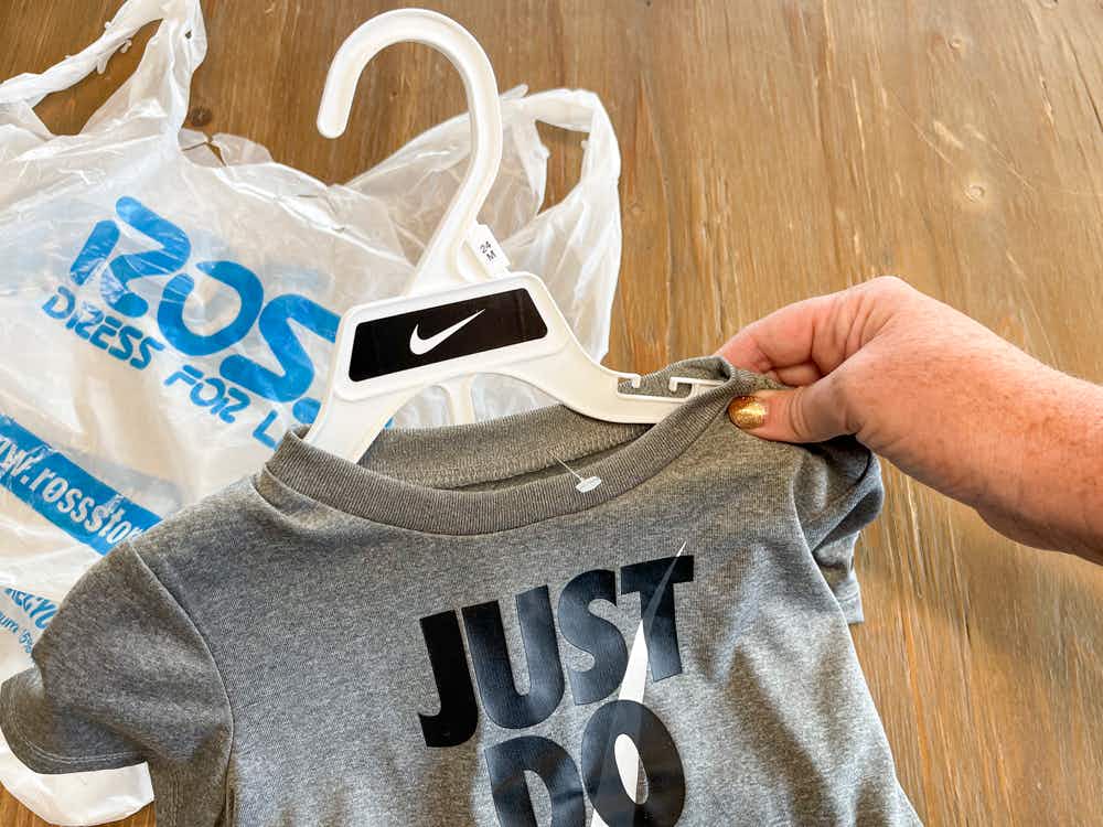 A kids Nike outfit with no tag next to a Ross shopping bag