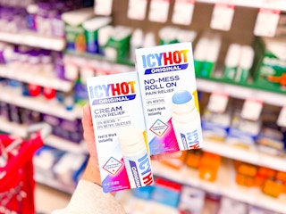 hand holding 2 icy hot pain relief products at target