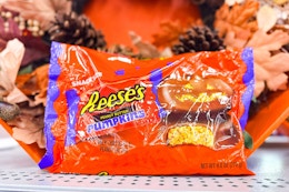 bag of reese's pumpkins in front of a fall wreath