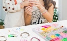 a mom and daughter making bracelets 