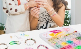 a mom and daughter making bracelets 