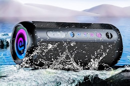 Lifestyle image of the Cascho Portable Bluetooth Speaker with water splashed on it to show that its waterproof