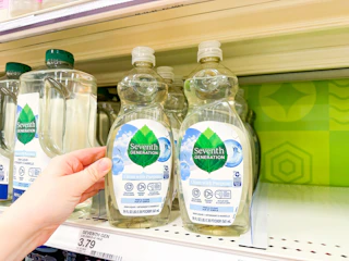 grabbing a bottle of seventh generation dish soap off a target shelf