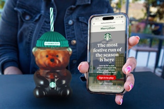 starbucks for life merrython on phone next to a starbucks cup