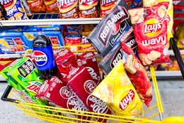 cart full of pizza, soda, and chips