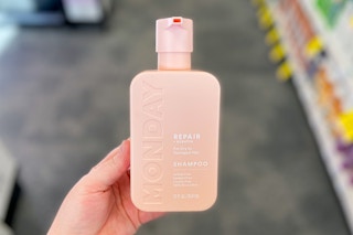 hand holding a bottle of Monday hair care in cvs