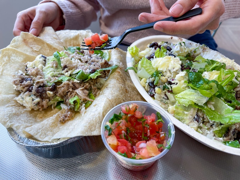someone putting salsa on a tortilla