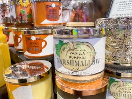 a fall scented candle on a display with other fall scented candles