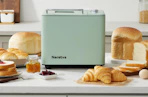 a mint bread maker on a counter with different breads