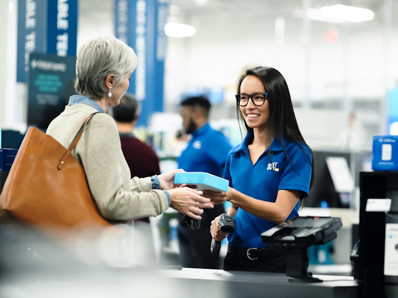 A customer talking to a Best Buy employee at checkout