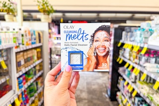 person holding a package of olay cleansing melts in an aisle