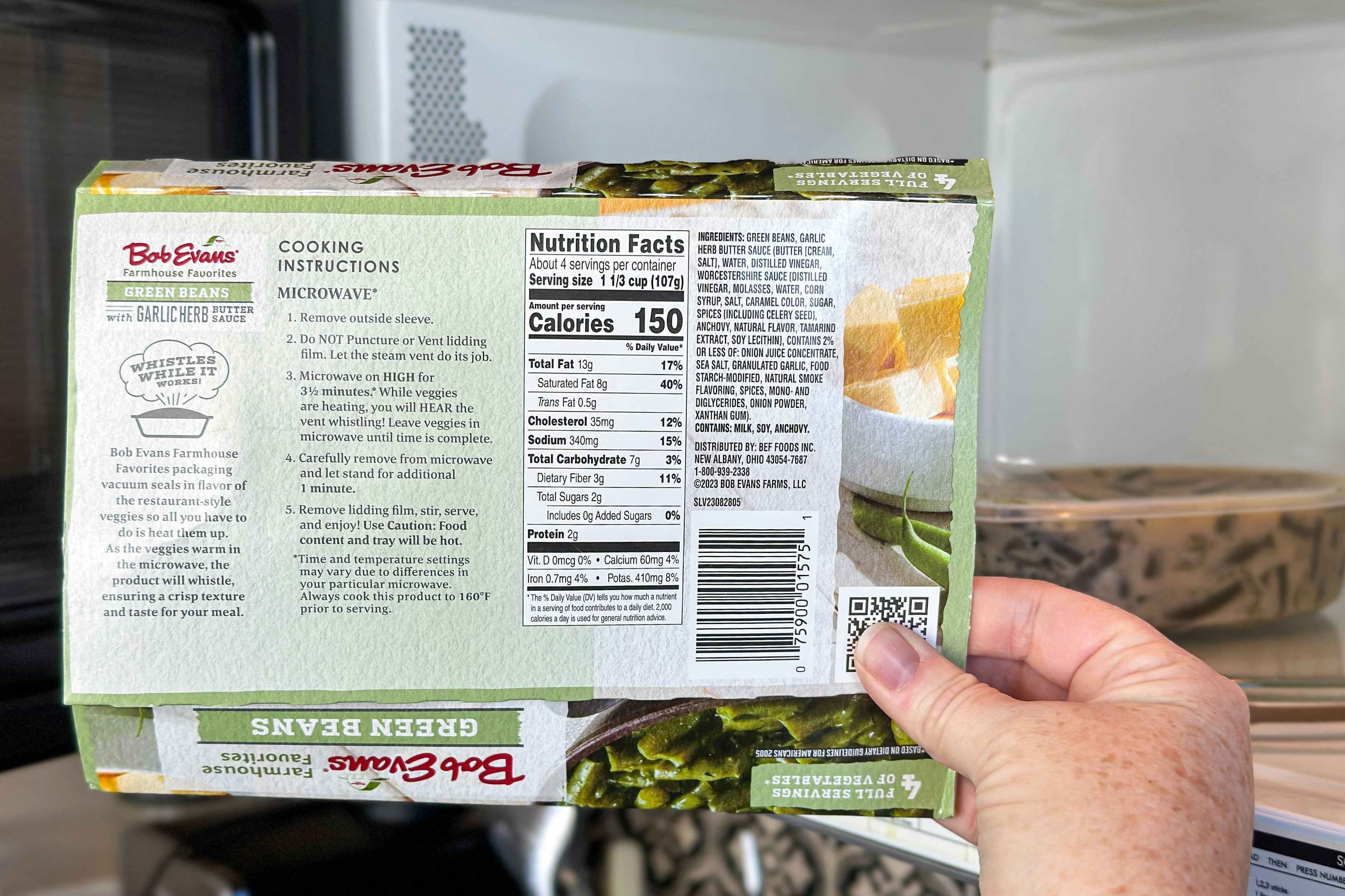 someone holding up a bob evans farmhouse favorites green beans box to show the cooking instructions