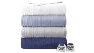 a stack of heated electric blankets in blues and white