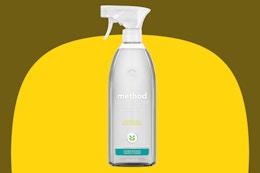 Method Daily Shower Spray Cleaner, Eucalyptus Mint on a yellow background.