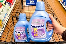 hand holding a bottle of snuggle softener