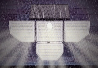 a flood light hanging on the side of a home