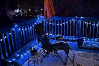 cool-toned sting lights on patio fence